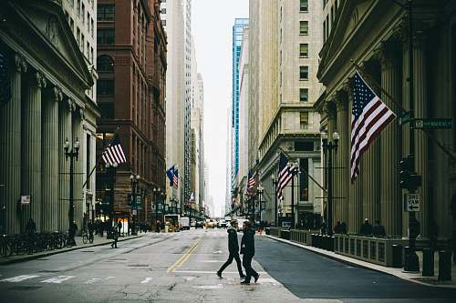 united states people walking on street near flag of U.S. America city